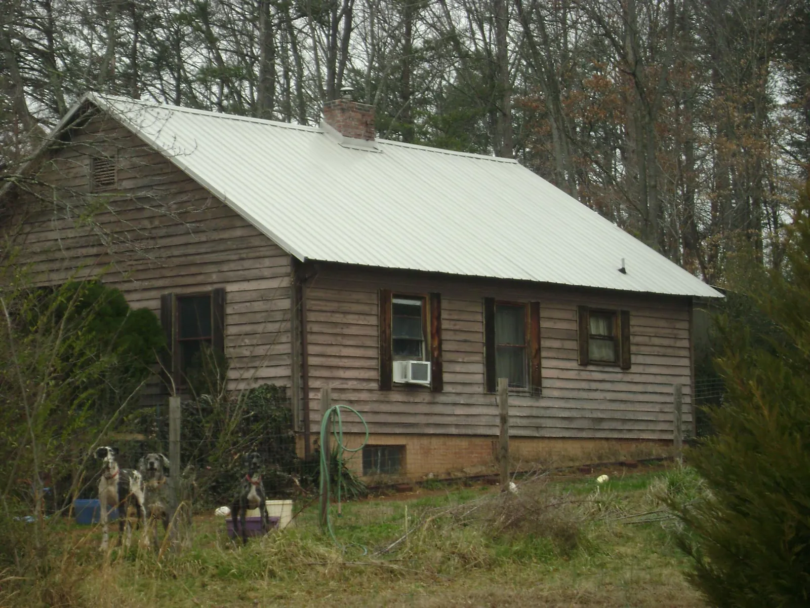 White metal roof on an old wood sided farmhouse, from a Metal Roof Installation job in Decatur